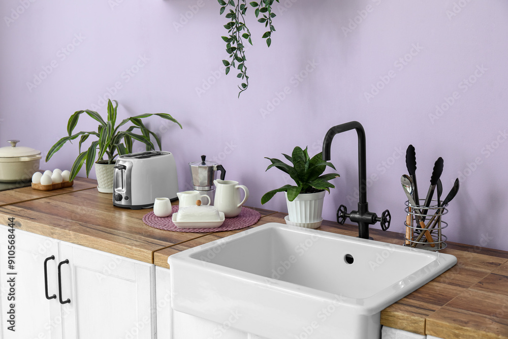 Modern kitchen with sink, toaster and kitchenware