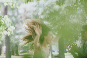 Poster - Vibrant scene of young adults having fun in a sunny park, capturing moments of joy and freedom with laughter and energy.