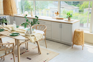 Poster - Beautiful setting with green branches on dining table in kitchen