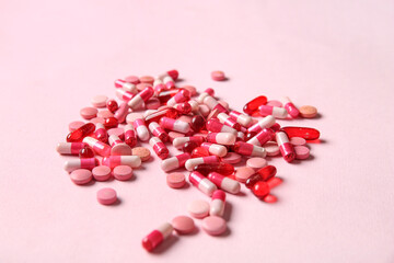 Wall Mural - Different pills on pink background, closeup