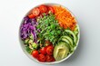 © At My Hat - A colorful salad with a variety of vegetables including broccoli, tomatoes, and avocado. The bowl is white and placed on a white background