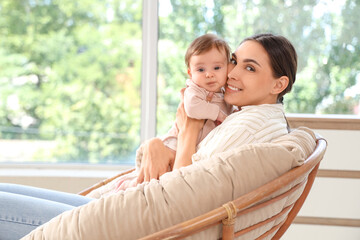 Canvas Print - Mother with her little baby sitting in armchair at home