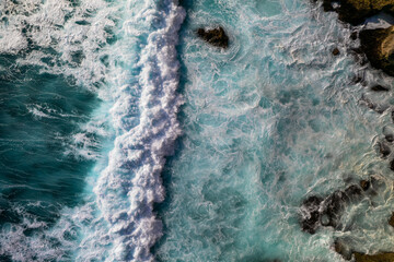 Wall Mural - Top down of waves crashing in ocean near Uluwatu temple in Bali, Indonesia