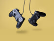© showcake - Flying air gamepads from a game console on a yellow background. The concept of games