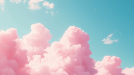 Wall Mural - soft pink clouds drift lazily across a clear blue sky, creating a serene and dreamy atmosphere.