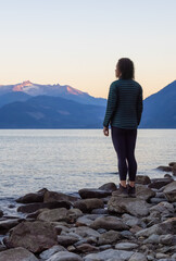 Wall Mural - Adventure Travel Woman standing at Harrison Lake at Sunny Summer Morning Sunrise.