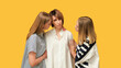 © golubovy - Caring support. Female encouragement. Worried women comforting upset depressed friend isolated on yellow free space background.