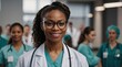 © VistaVisions - Happy black African American female doctor standing blurry hospital clinic background