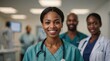© VistaVisions - Happy black African American female doctor standing blurry hospital clinic background