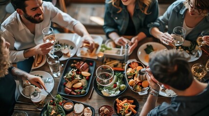 Wall Mural - A group of friends are enjoying a meal together at a table.