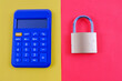© MH Capture - A calculator and padlock isolated with yellow and red background.