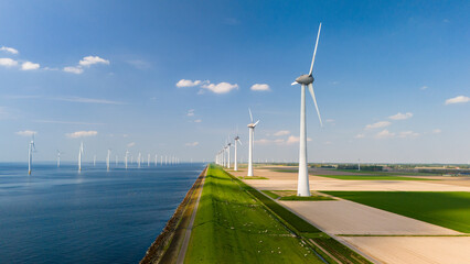 Wall Mural - Wind Turbines Dancing Against the Blue Skies of the Dutch Coastline