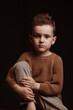 © alexkoral - Portrait of a serious sad stylish white caucasian child boy kid preschooler a chair