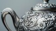 © Paul - Detailed close-up of a silver teapot with ornate engravings, isolated on a clean background, providing space for text or branding