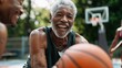 © Denisa - Two elderly men share laughter while playing basketball on an outdoor court during a bright afternoon