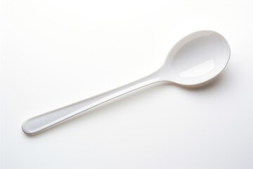 Sticker - A plastic spoon white white background silverware.