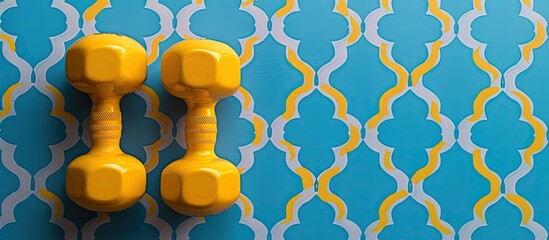 Poster - Dumbbell weights in yellow shade positioned against a backdrop of a blue pattern with ample copy space image included