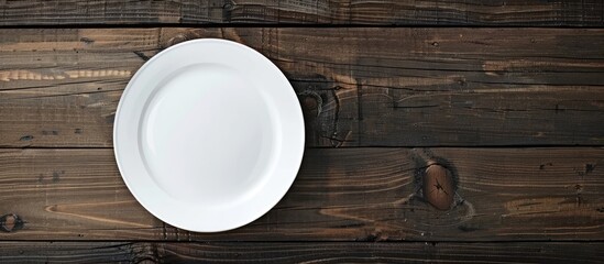 Poster - Wooden background showcasing an empty white plate with copy space image