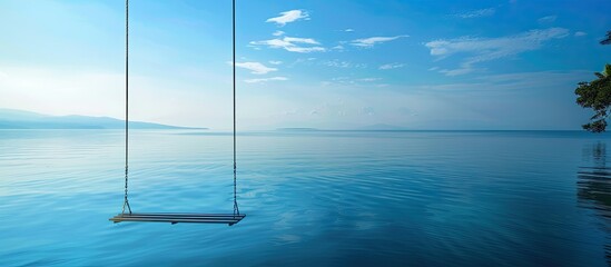 Poster - Serene sea view with an empty swing offering copy space image Peaceful morning by the water reflecting a tranquil seaside scene for a romantic getaway
