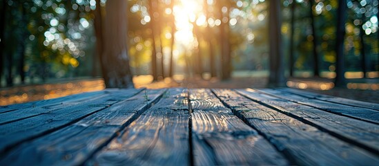 Poster - Product displayed on a wooden table with a blurred background of trees with bokeh effect providing ample copy space image