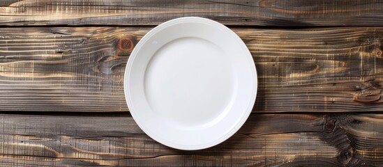 Poster - Wooden backdrop with a blank clean white plate ideal for showcasing a fresh meal Versatile for text and signs in a copy space image