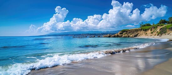 Wall Mural - scenic coastal view with clear blue skies and fluffy clouds on a sunny day featuring a wide copy spa