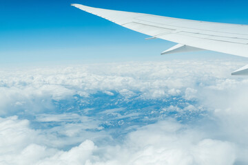 Wall Mural - view from an airplane on a blue sky and white clouds