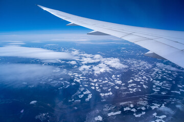 Wall Mural - view from an airplane on a blue sky and white clouds