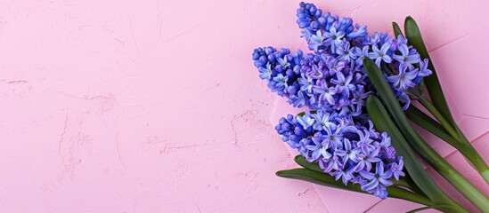 Poster - Mockup of a greeting card featuring a spring hyacinth bouquet with an envelope set against a pretty pink paper background providing ample space for text or design