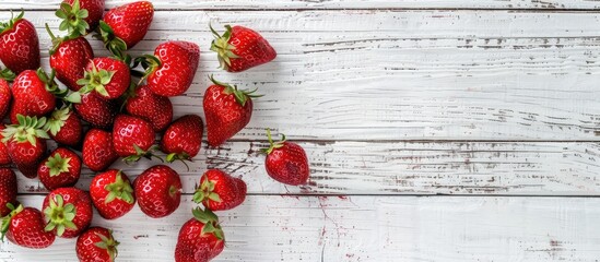 Aufkleber - Top view of ripe red strawberries on a rustic white wooden background with copy space image