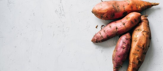 Wall Mural - Sweet potato on a plain white backdrop with copy space image