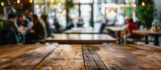 Aufkleber - Copy space image of a wooden table top in a bustling cafe with a blurred background of people ideal for display montage
