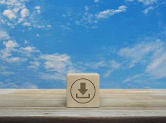 Poster - Download icon on wood block cube on wooden table over blue sky with white clouds, Technology internet online concept