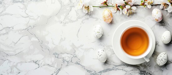 Fototapete - Easter themed mock up featuring a teacup flowers and marble background with copy space image