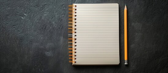 Poster - Copy space image of a notepad and pencil against a dark background