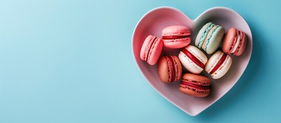 Aufkleber - A Valentine s Day card featuring macaroons on a heart shaped plate against a blue background displayed from above with copy space image