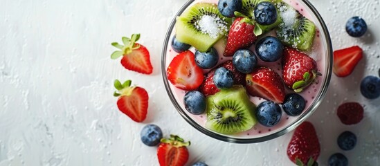 Poster - Enjoy a nutritious breakfast featuring strawberry yogurt topped with blueberries kiwi slices and sugar glass set against a background of copy space image