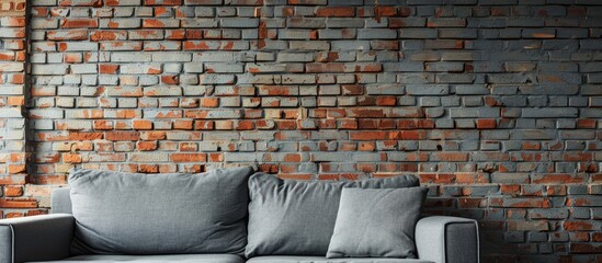 Poster - Design banner with a grey sofa placed against a brick wall featuring ample copy space image