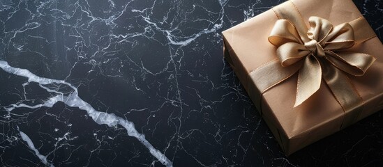 Leinwandbilder - Top view of a gift box placed on a black marble surface with empty space for text or images in the background. Creative banner. Copyspace image