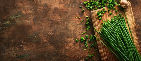 Aufkleber - Fresh spring chives on a wooden board with ample copy space image