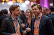 © gabriele - Business men and delegates networking at a conference drinks reception. Attendees engage in professional interaction and socializing, seizing the opportunity to make relationships