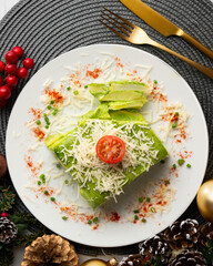 Wall Mural - Baked potatoes with spinach bechamel and cheese on a table with christmas decorations.