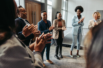 Wall Mural - diverse group of people clapping in a circle during a seminar