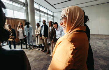 Wall Mural - diverse team bonding activity with muslim woman in circle during workshop
