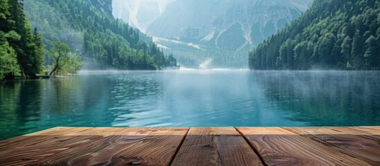 Fototapete - Display shelf made of wood against a serene background of blurry turquoise lake and misty landscape ideal for a copy space image