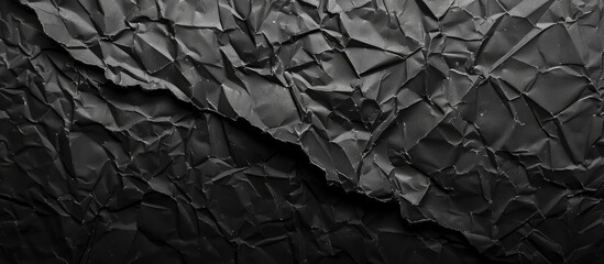 Poster - Background with a grungy texture created by crumpled black paper ideal for adding text or images featuring ample copy space image