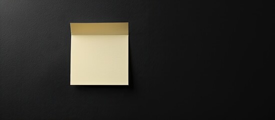 Poster - A black background with a blank paper note attached ideal for including an image with empty space for text. copy space available