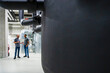 © Westend61 - Two employees using laptop in factory