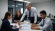 © YENI - Group of people working out business plan in an office