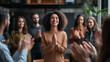 © Sadia - Celebration of Success With Group Applauding Woman in Cozy Indoor Setting